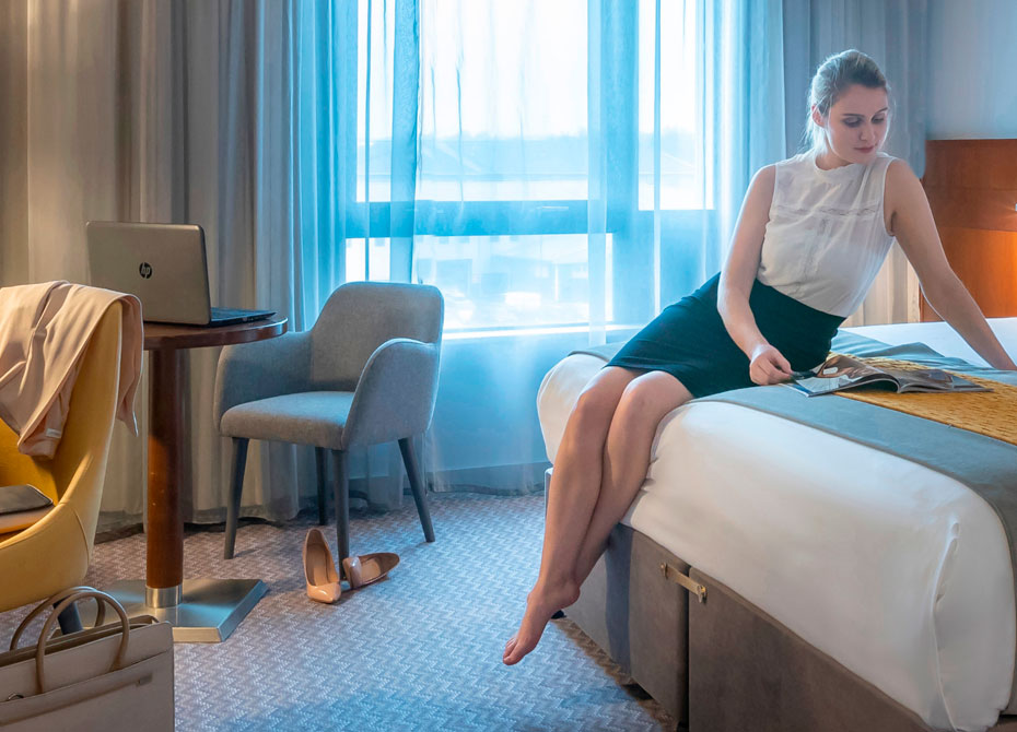 business woman sitting bedside